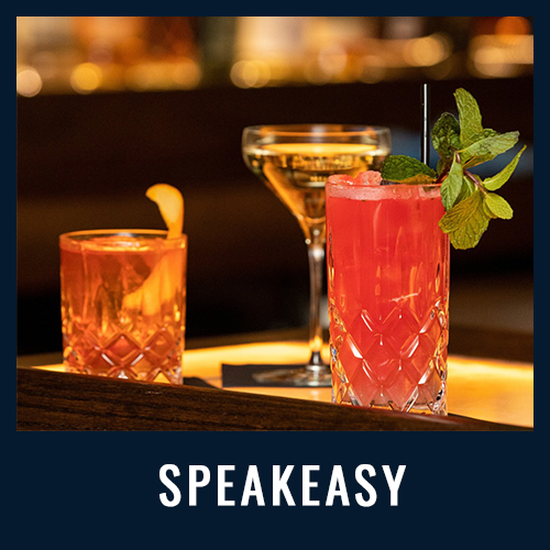 Three elegant cocktails on a dimly lit bar, including a pink drink with mint garnish
