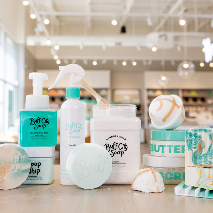 Buff City Soap products including soap, scrub, butter and laundry soap displayed on a counter.